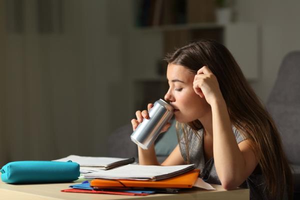 teen drinking out of a can while studying, parenting is harder